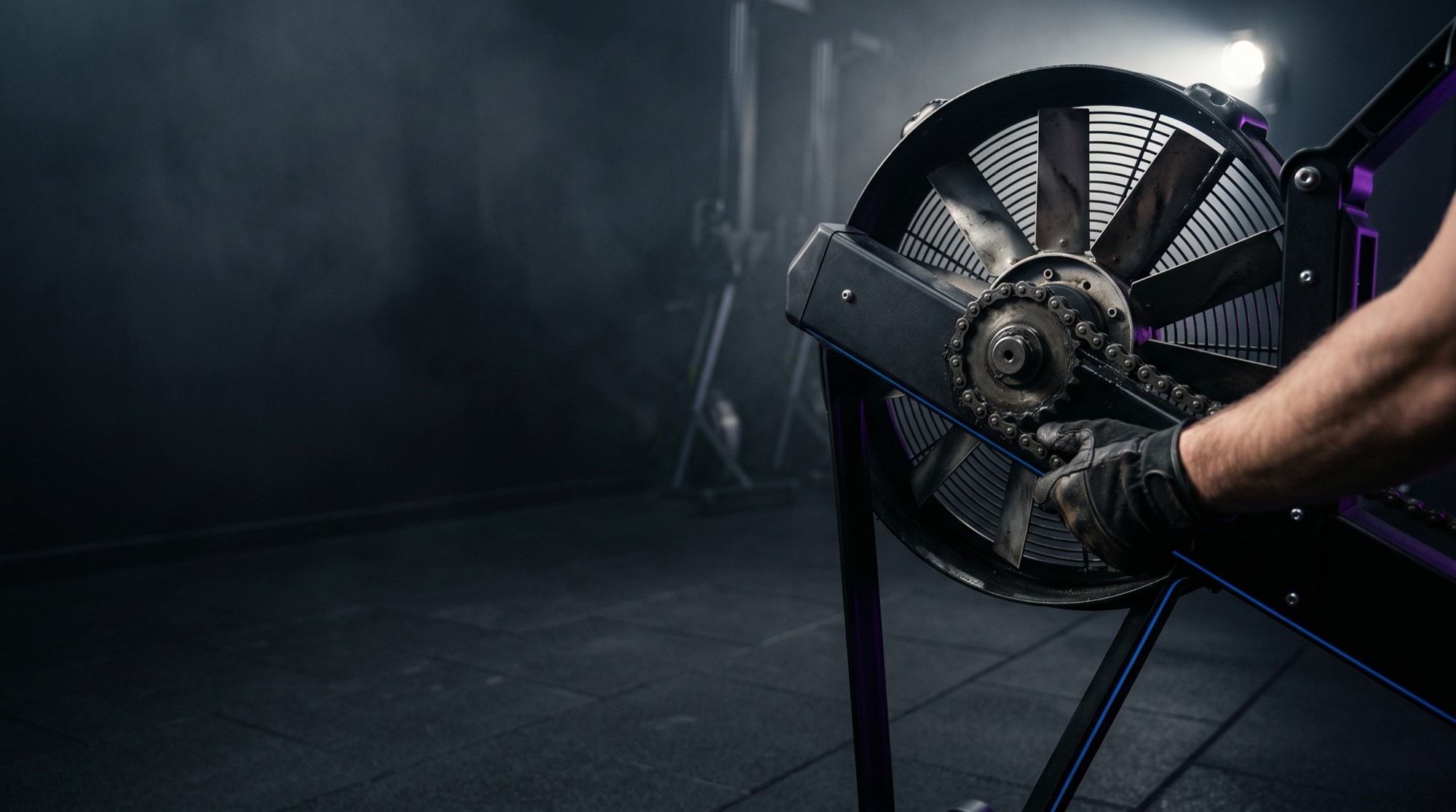 Air-resistance ergometer flywheel and chain being serviced